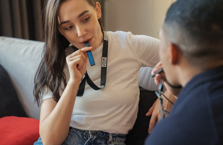 woman in white t shirt using cbd vape for anxiety