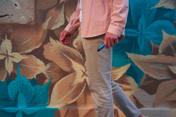 man in pink shirt vaping CBD